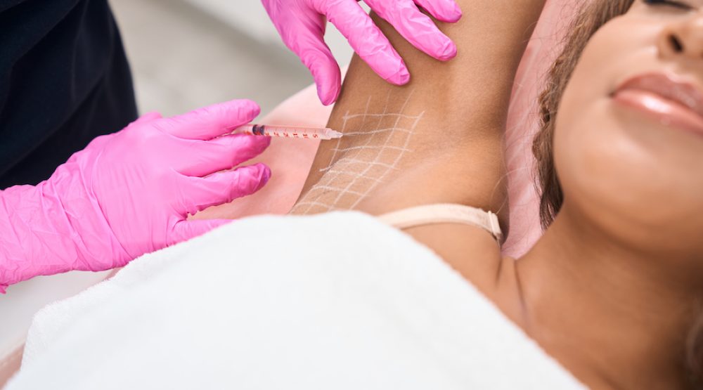 Young patient receives injections in the armpit area Young patient receives injections in the armpit area